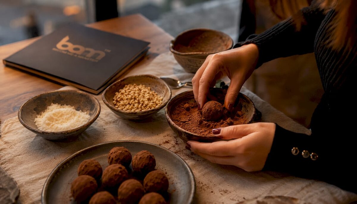 Overhead view of truffle coating with cocoa powder