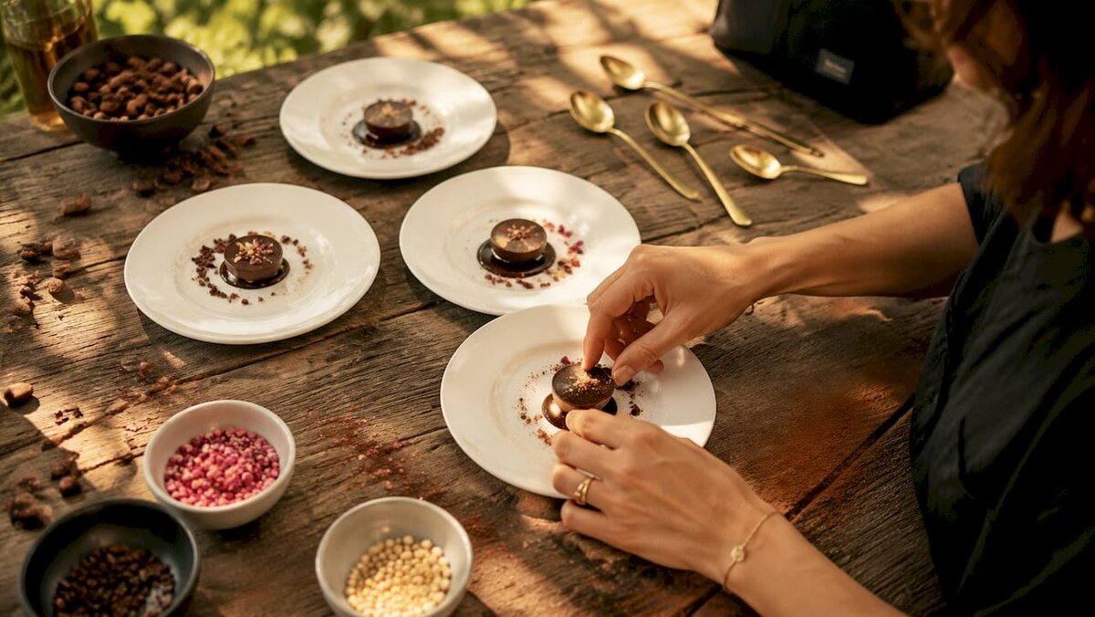 Close-up of hands customizing branded chocolates