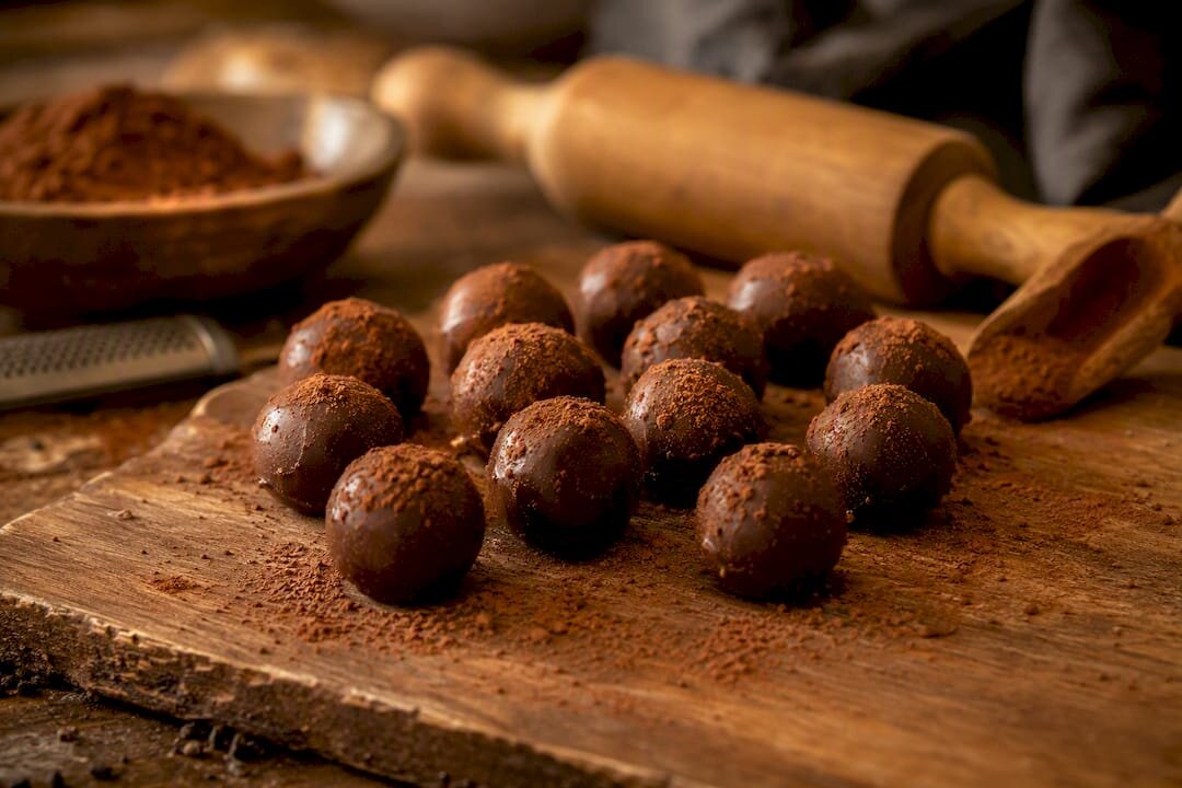 Rolled chocolate truffles on marble slab